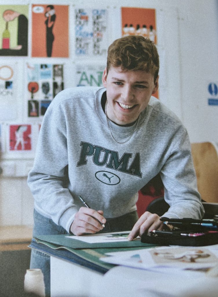 Daniel Keyse in grey Puma sweatshirt.